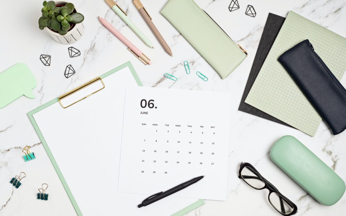 Desktop with calendar for june and office supplies. home office, social media blog