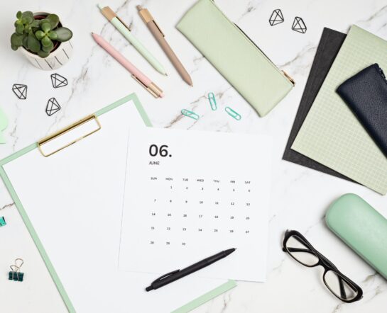 Desktop with calendar for june and office supplies. home office, social media blog