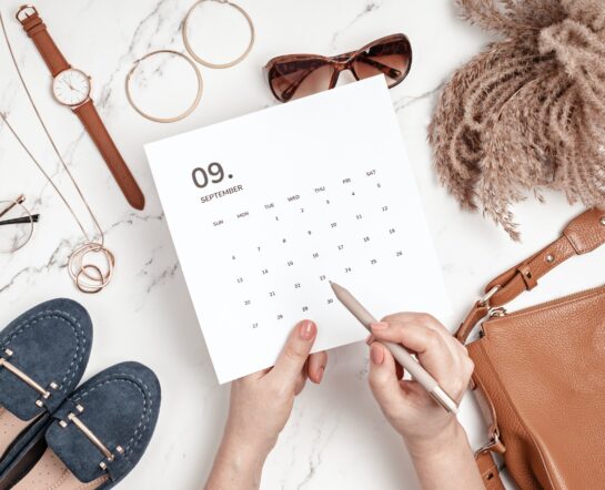Flat lay with calendar for September with woman fashion fall accessories