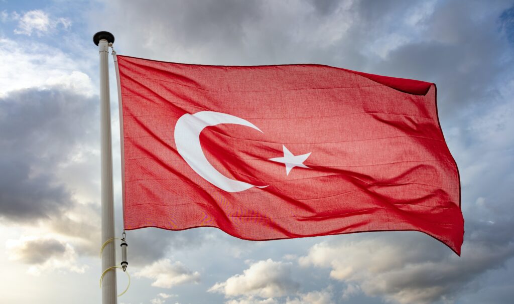 Turkey flag waving against cloudy sky