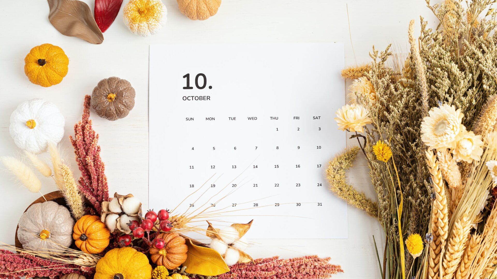 Flat lay with calendar for october with autumn table decoration