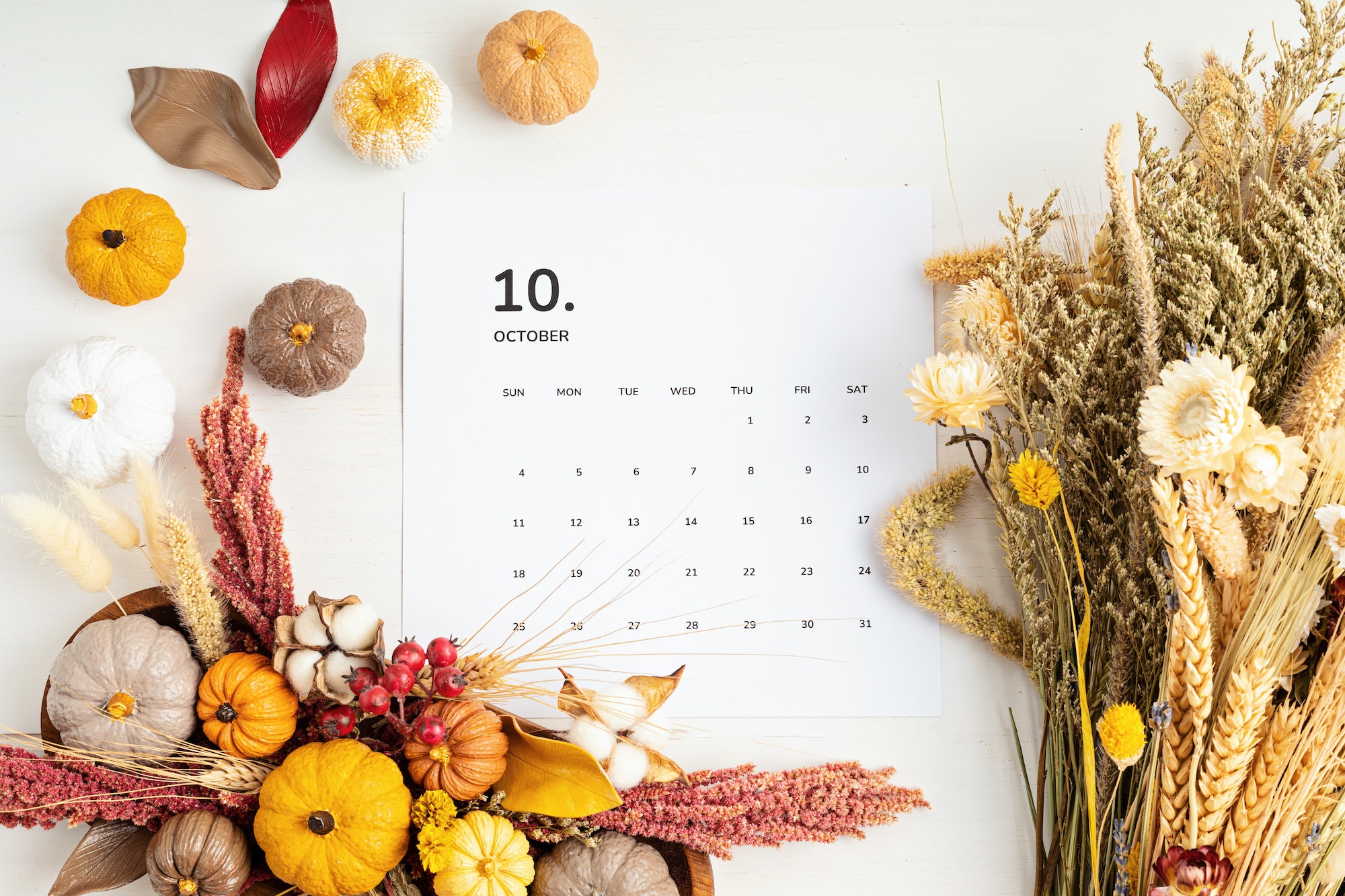 Flat lay with calendar for october with autumn table decoration