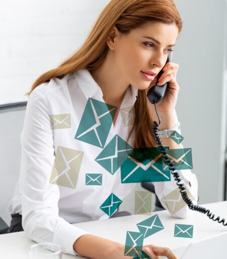 Successful businesswoman using laptop and talking on phone at office table, e-mail illustration