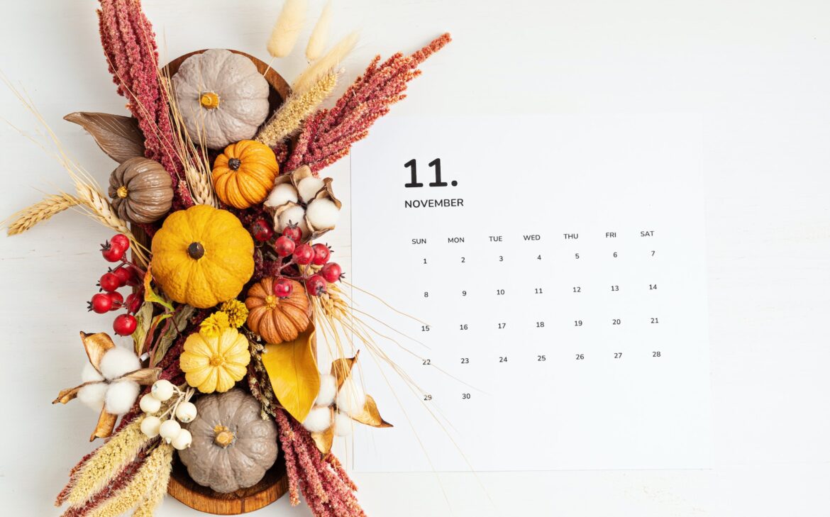 Flat lay with calendar for november with autumn table decoration