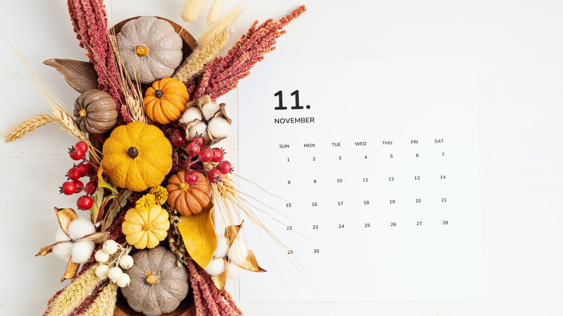Flat lay with calendar for november with autumn table decoration