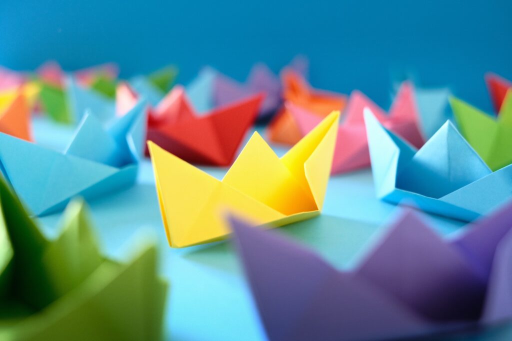 Origami Boats On Blue Background
